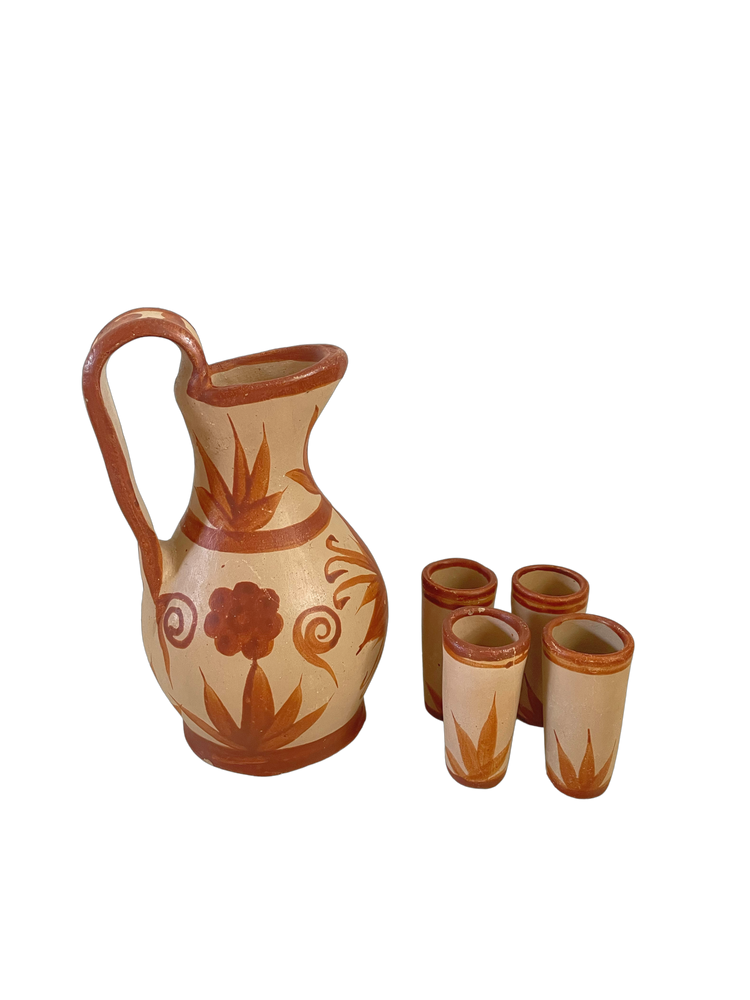 Red clay pitcher and shot glasses