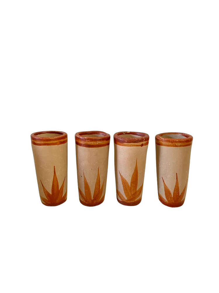 Red clay pitcher and shot glasses